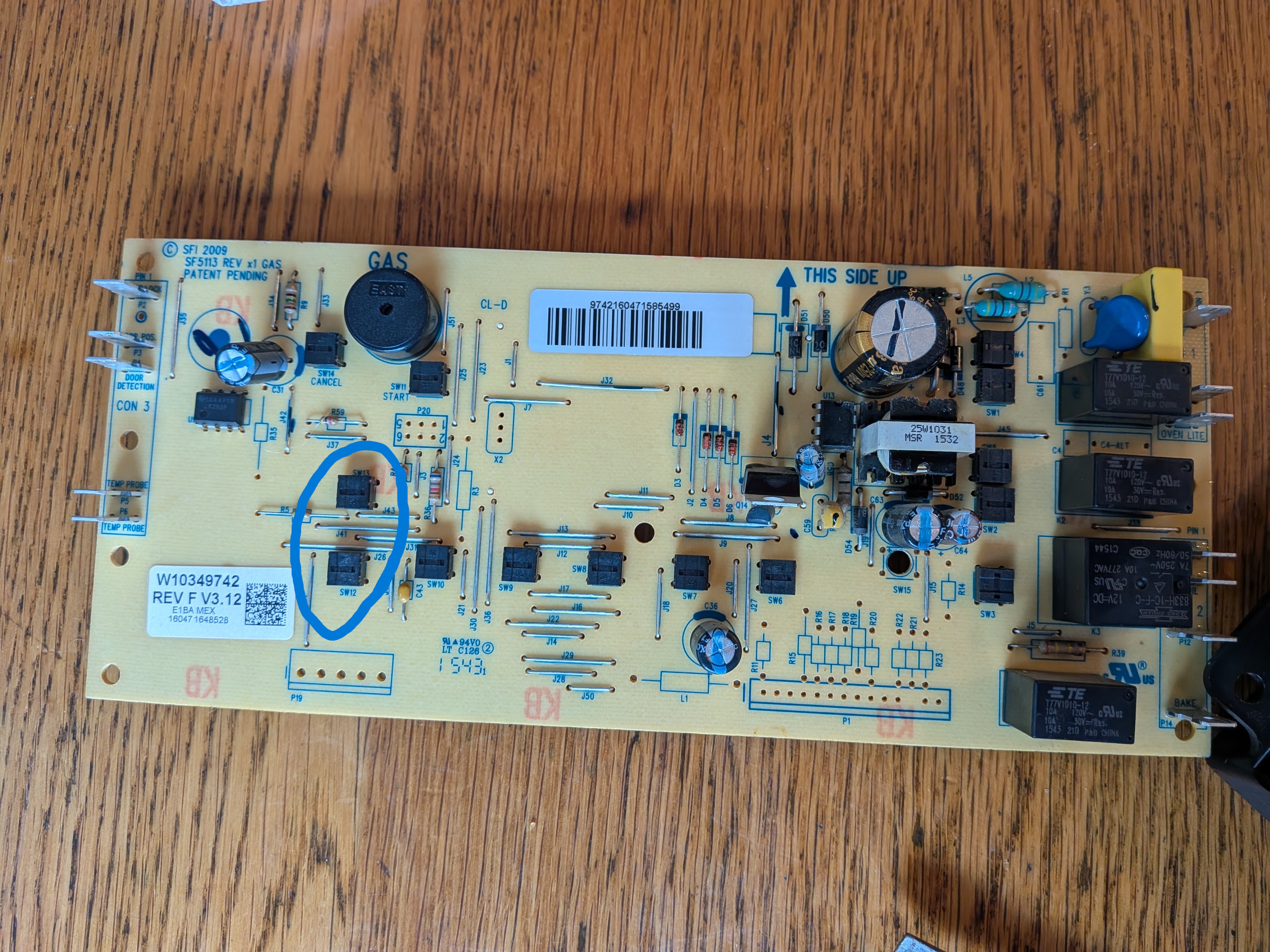 Back of the circuit board, button switch points are visible. One of the circled switches wasn't being pushed.